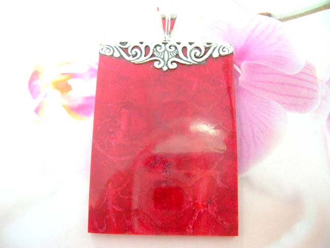 Online fashion collectible exporter, Wind and wave 925. sterling silver mounted fashion pendant with coral colored gemstone