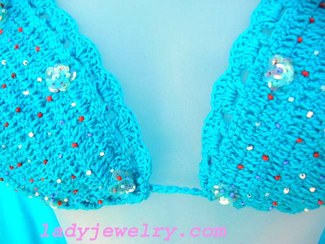 Sexy bikini swimsuit in artisan crafted crochet design with sequin flower decor. Stylish tropical beach supply clothing 